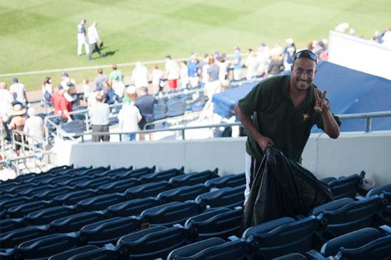 trash pickup in the stands at charlotte sports park